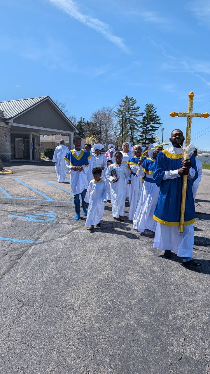 Agashadua Parish worshipers in white and blue ceremonial garments during an outdoor procession