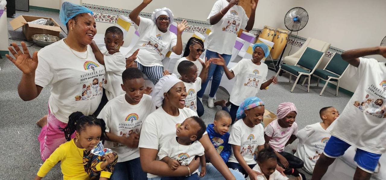 Children and adults of Agashadua Parish sharing a joyful family gathering